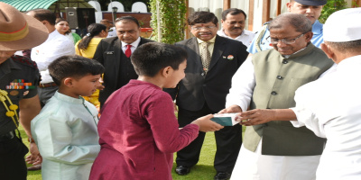 The Governor distributing sweets on the occasion of Independence Day